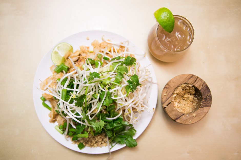 tofu pad thai on a plate with a margarita on the side
